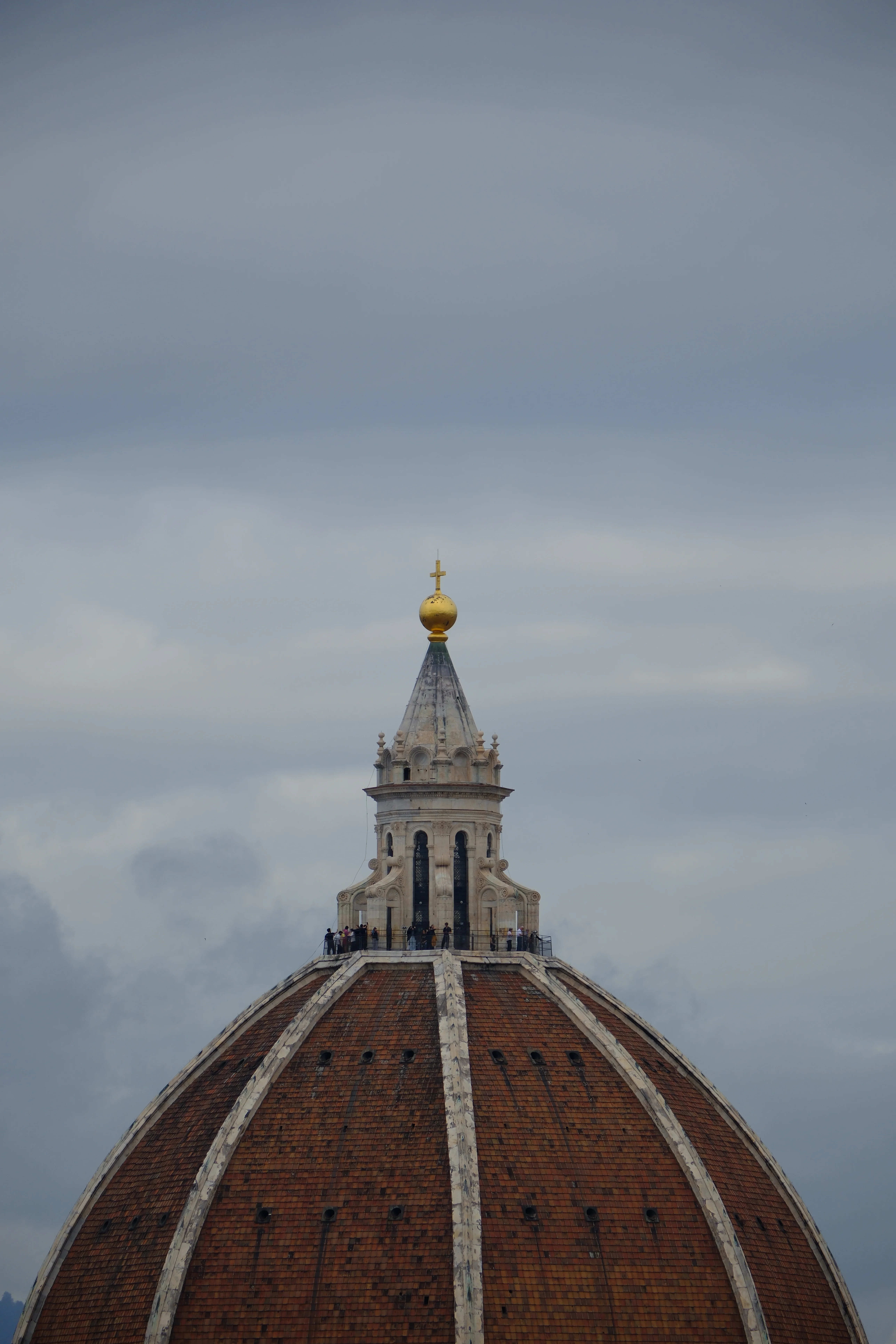 300mm · f/5.6 · 1/640s · ISO 200
FUJIFILM X-T5 · XF70-300mmF4-5.6 R LM OIS WR · Oct 13, 2024
Red tiled dome of Florence Cathedral with a golden cross.
Florence, Italy
© Brandon Cook