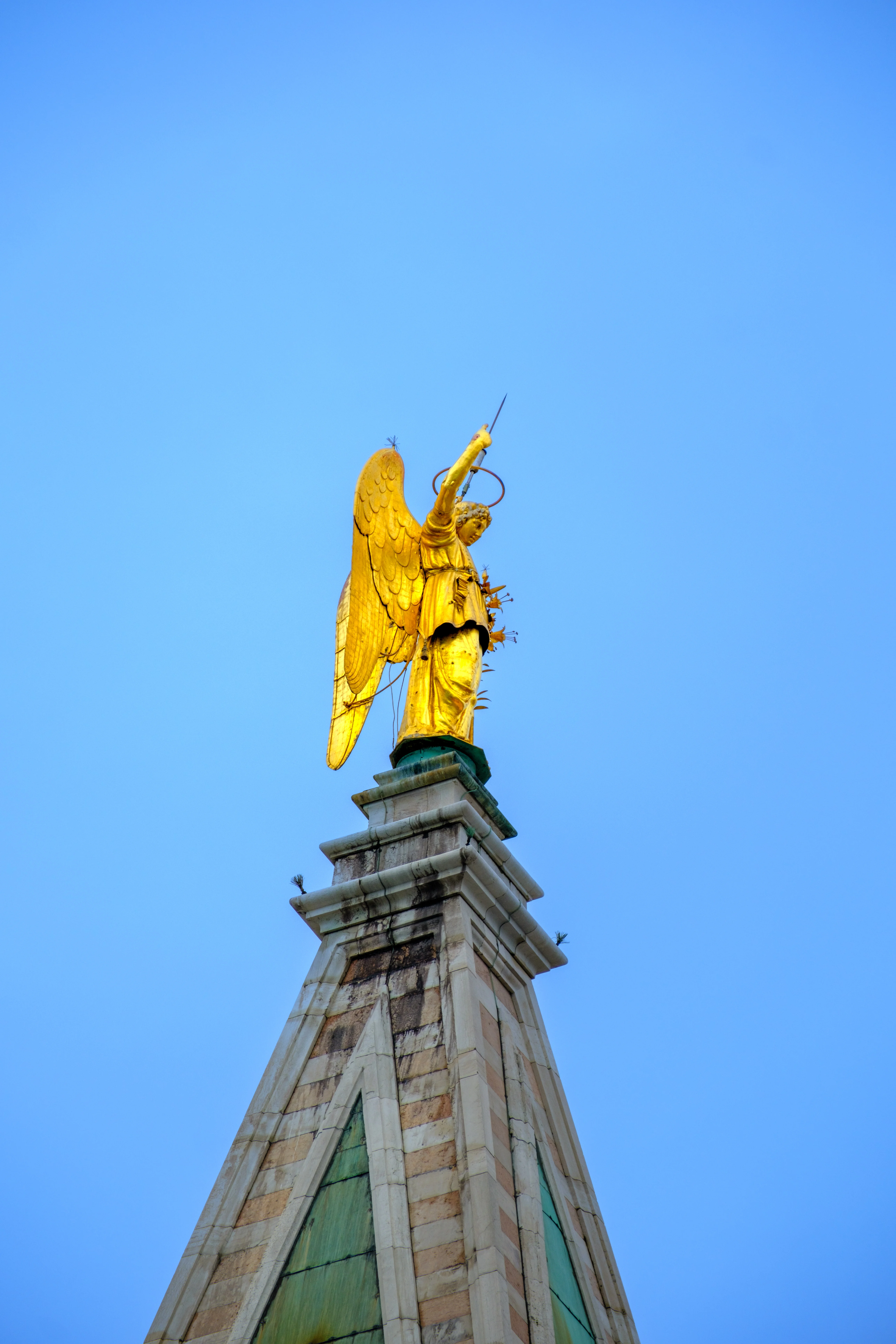 300mm · f/5.6 · 1/1000s · ISO 125
FUJIFILM X-T5 · XF70-300mmF4-5.6 R LM OIS WR · Oct 19, 2024
Golden angel statue atop a stone spire in Venice, Italy.
Venice, Italy
© Brandon Cook
