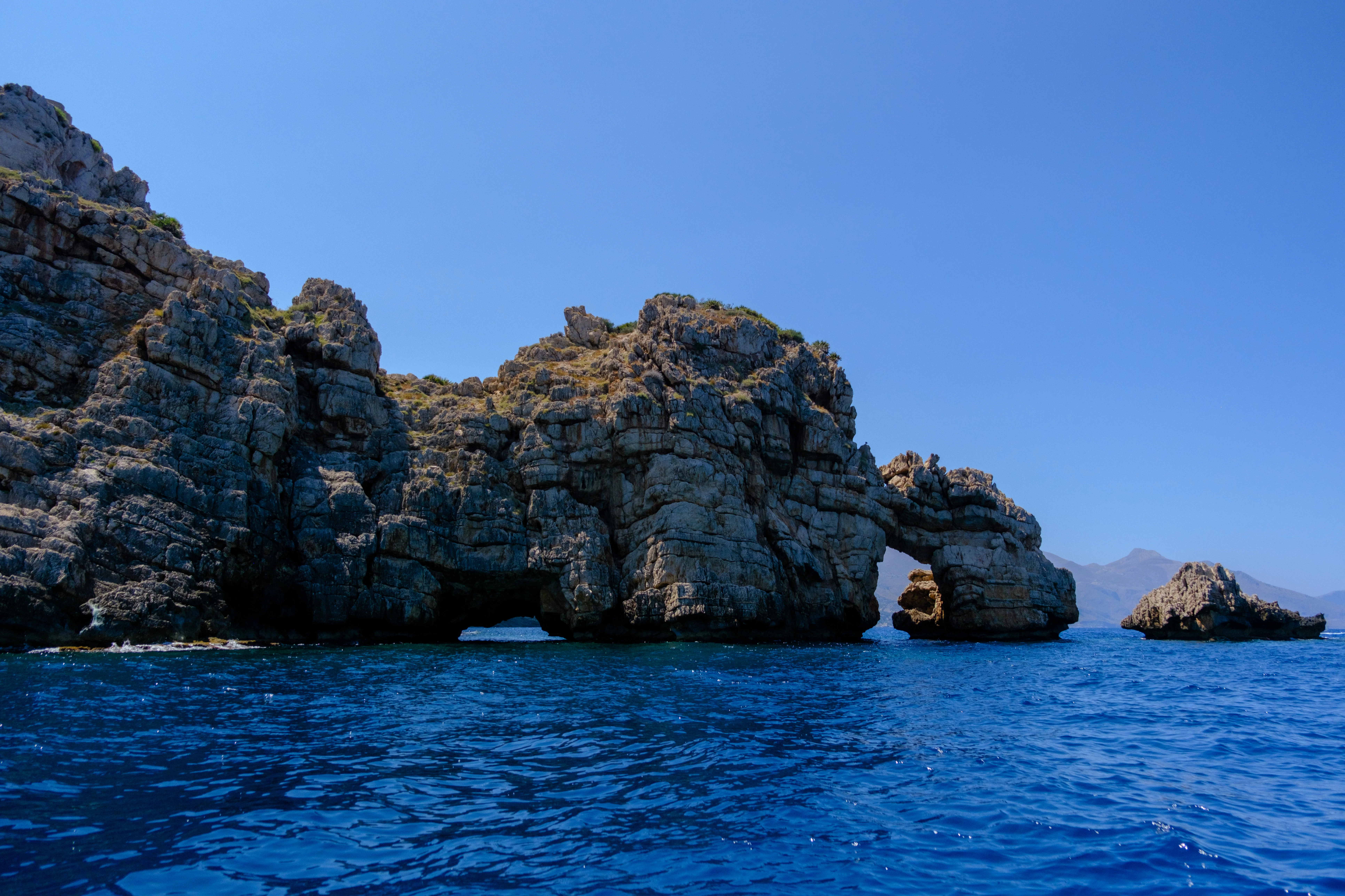 18mm · f/3.2 · 1/6400s · ISO 200
FUJIFILM X-T5 · XF18-55mmF2.8-4 R LM OIS · Jul 19, 2024
Jagged rocky cliffs and natural sea arch in blue water.
Sicily, Italy
© Brandon Cook