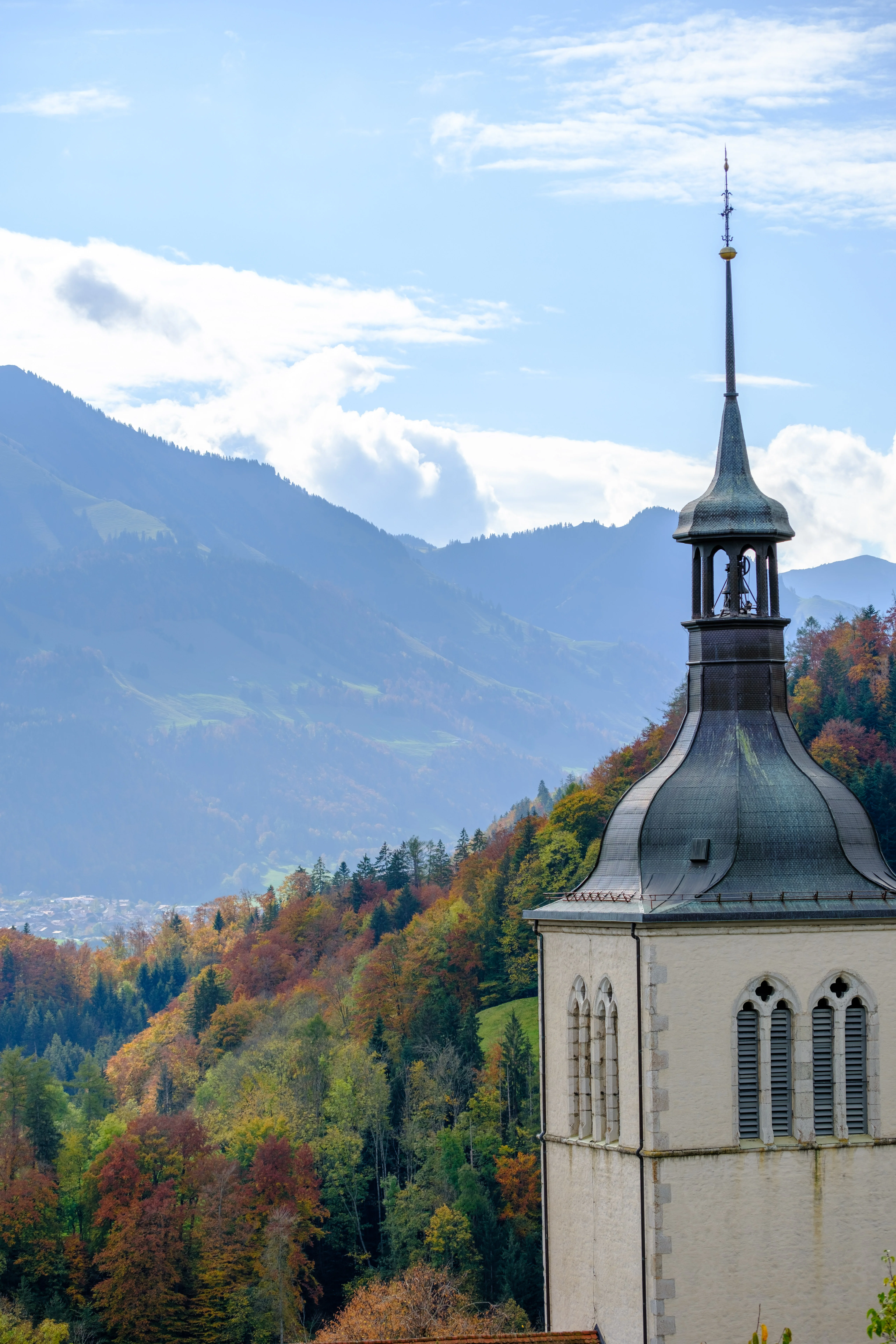 70mm · f/4 · 1/1100s · ISO 125
FUJIFILM X-T5 · XF70-300mmF4-5.6 R LM OIS WR · Oct 22, 2024
Church tower overlooking autumn forests and mountains in Gruyères, Switzerland.
Gruyères, Switzerland
© Brandon Cook