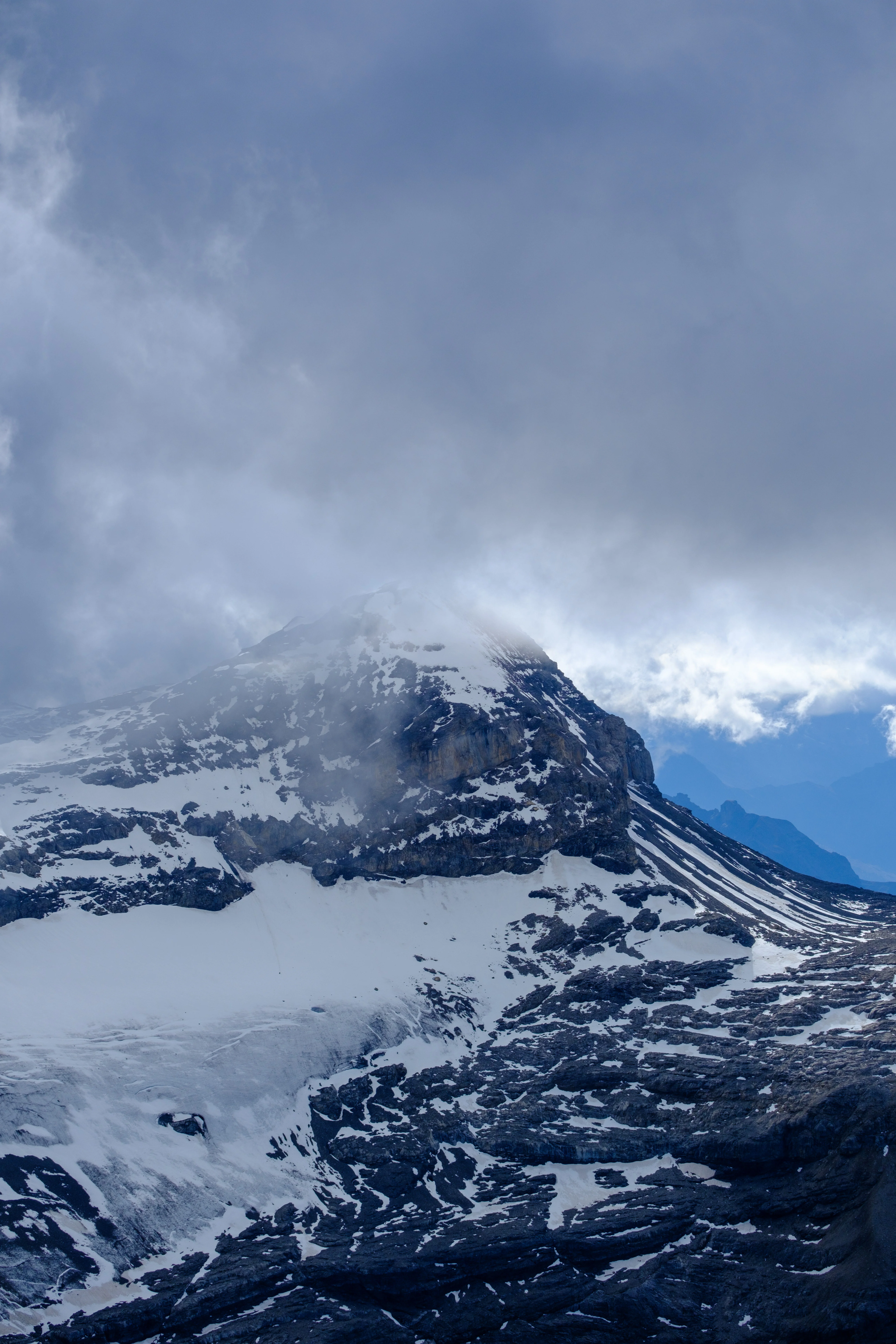 70mm · f/4 · 1/3500s · ISO 125
FUJIFILM X-T5 · XF70-300mmF4-5.6 R LM OIS WR · Oct 24, 2024
Snow-capped mountain peak shrouded in thick grey clouds.
Saanen, Switzerland
© Brandon Cook