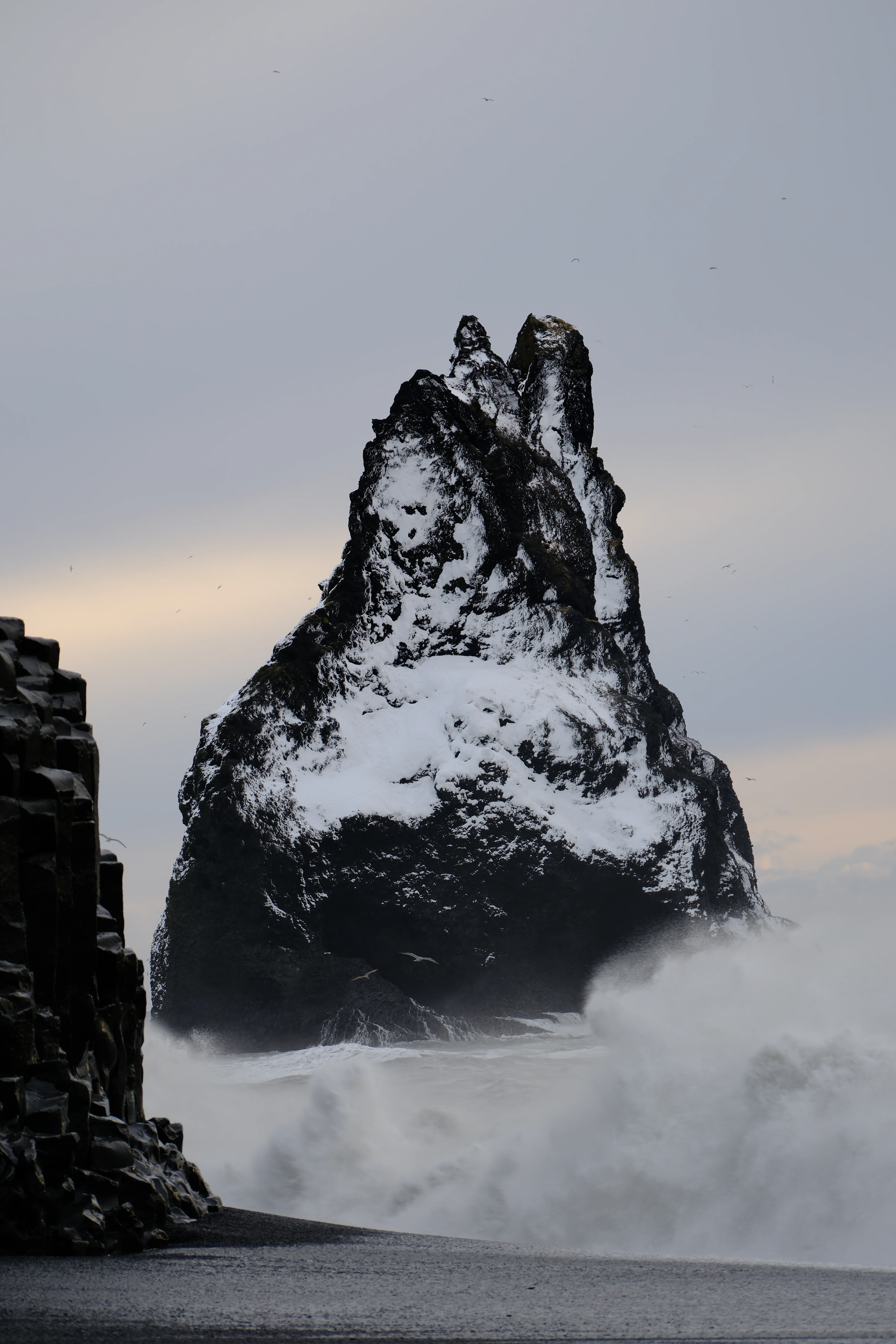 142mm · f/5 · 1/125s · ISO 160
FUJIFILM X-T5 · XF70-300mmF4-5.6 R LM OIS WR · Jan 25, 2025
Jagged snow-covered sea stack amidst crashing waves and mist.
Selfoss, Iceland
© Brandon Cook