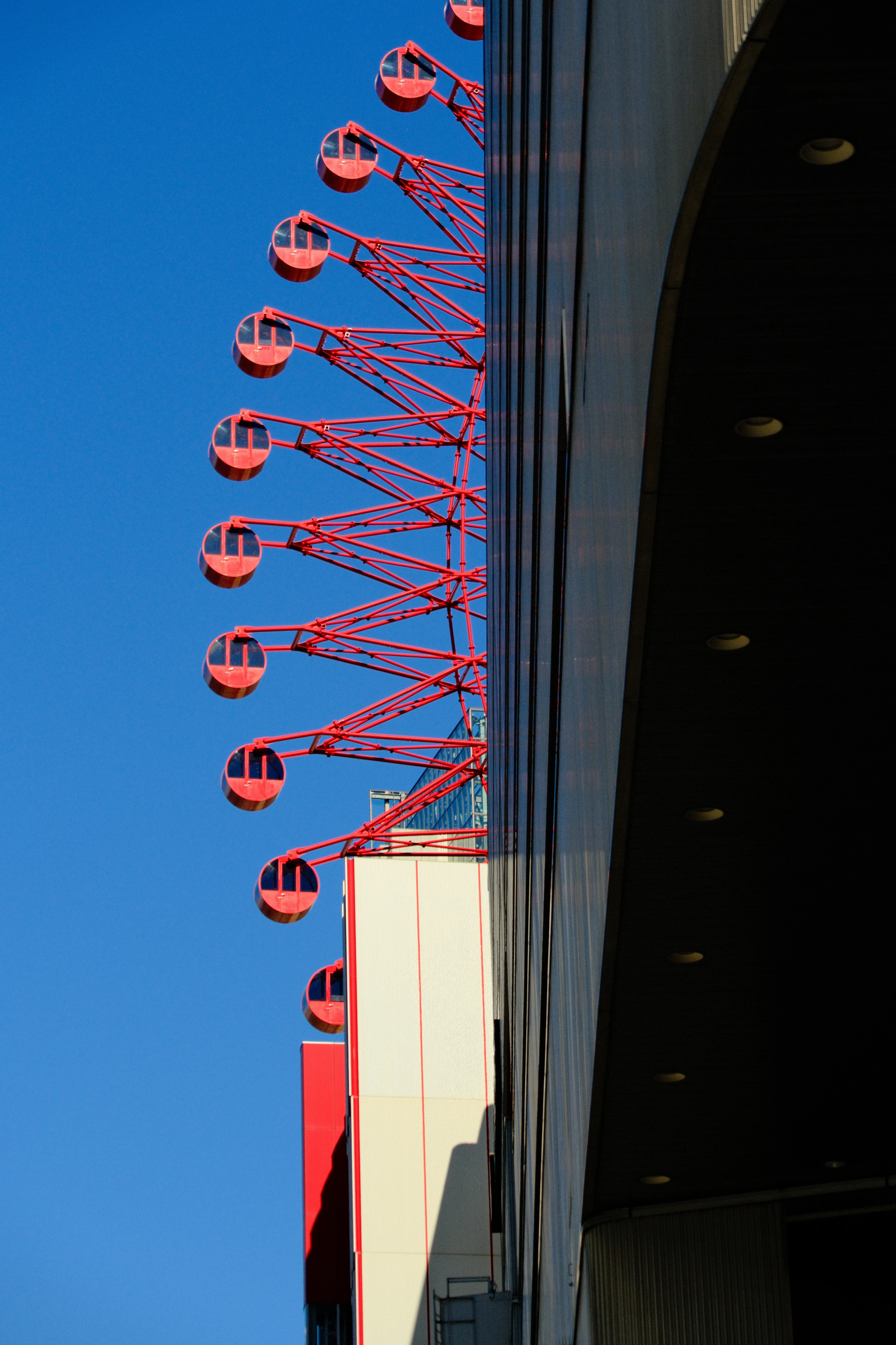 75mm · f/6.3 · 1/2400s · ISO 500
FUJIFILM X-T5 · 16-300mm F3.5-6.7 DC OS | Contemporary 025 · Jan 6, 2026
Red Ferris wheel gondolas against a clear blue Osaka sky.
Osaka, Japan
© Brandon Cook