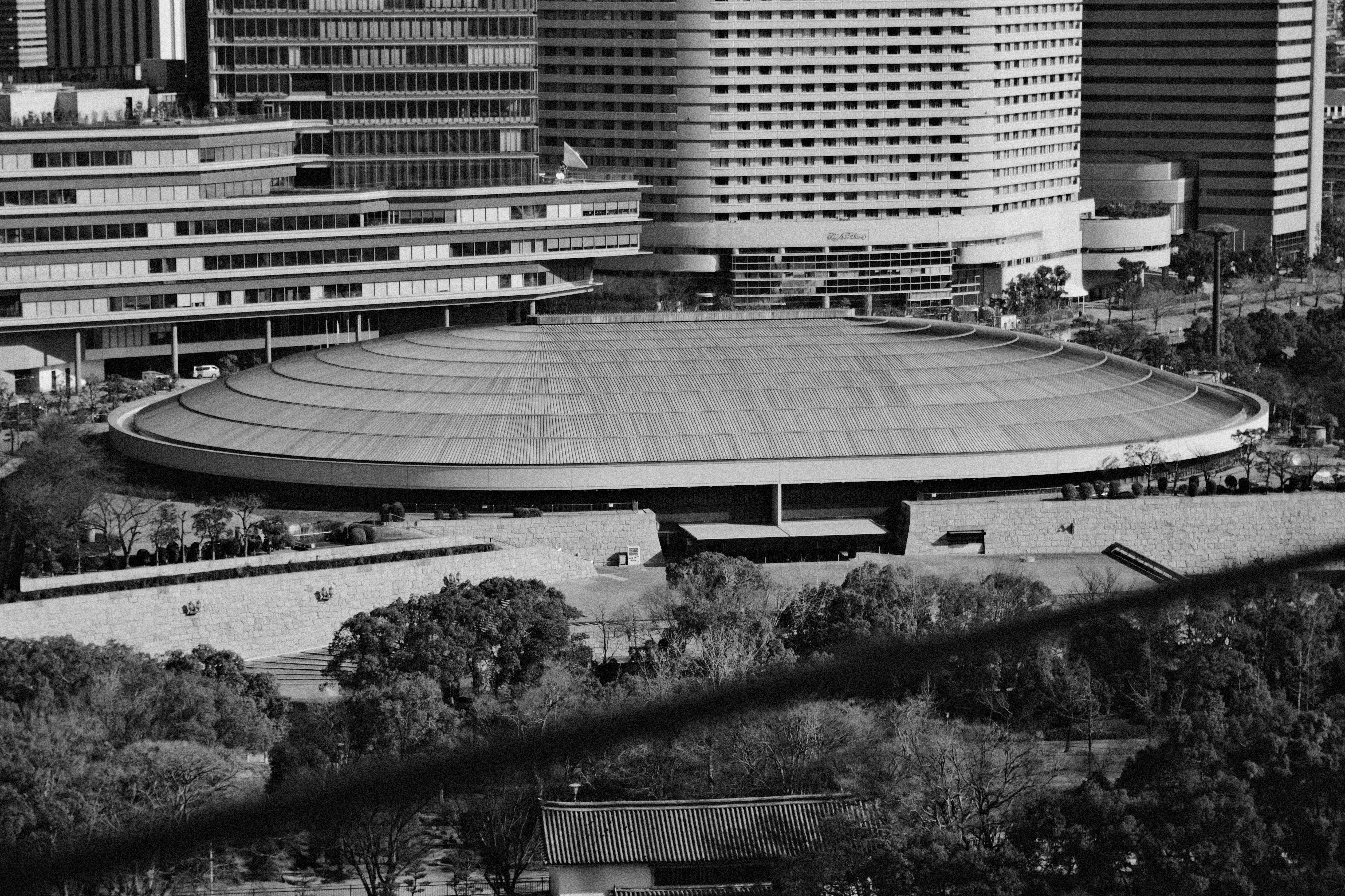 71mm · f/5.6 · 1/950s · ISO 250
FUJIFILM X-T5 · 16-300mm F3.5-6.7 DC OS | Contemporary 025 · Jan 7, 2026
Large tiered circular building surrounded by skyscrapers and trees.
Osaka, Japan
© Brandon Cook