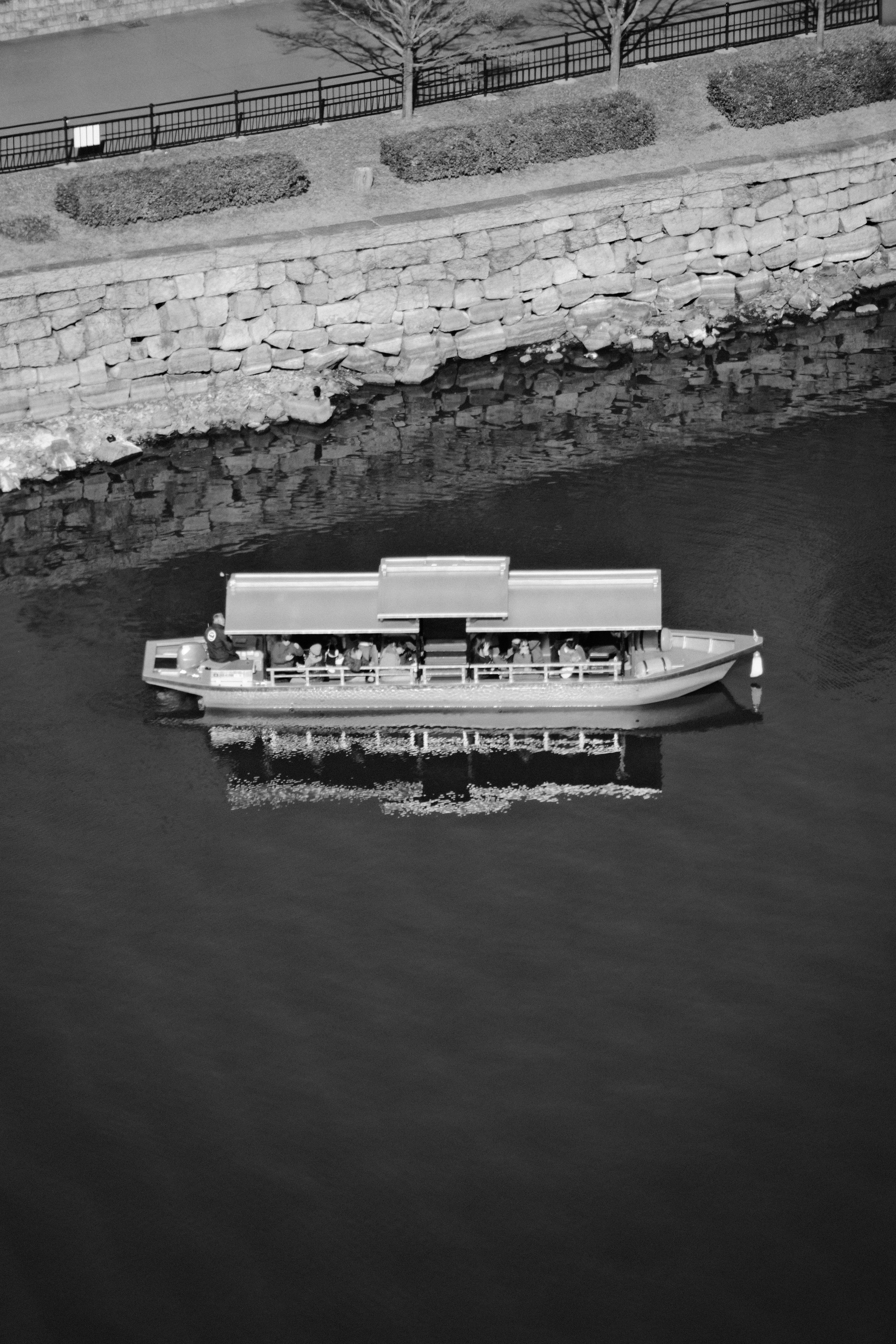 156mm · f/6.3 · 1/450s · ISO 250
FUJIFILM X-T5 · 16-300mm F3.5-6.7 DC OS | Contemporary 025 · Jan 7, 2026
Black and white aerial view of boat in Osaka canal.
Osaka, Japan
© Brandon Cook