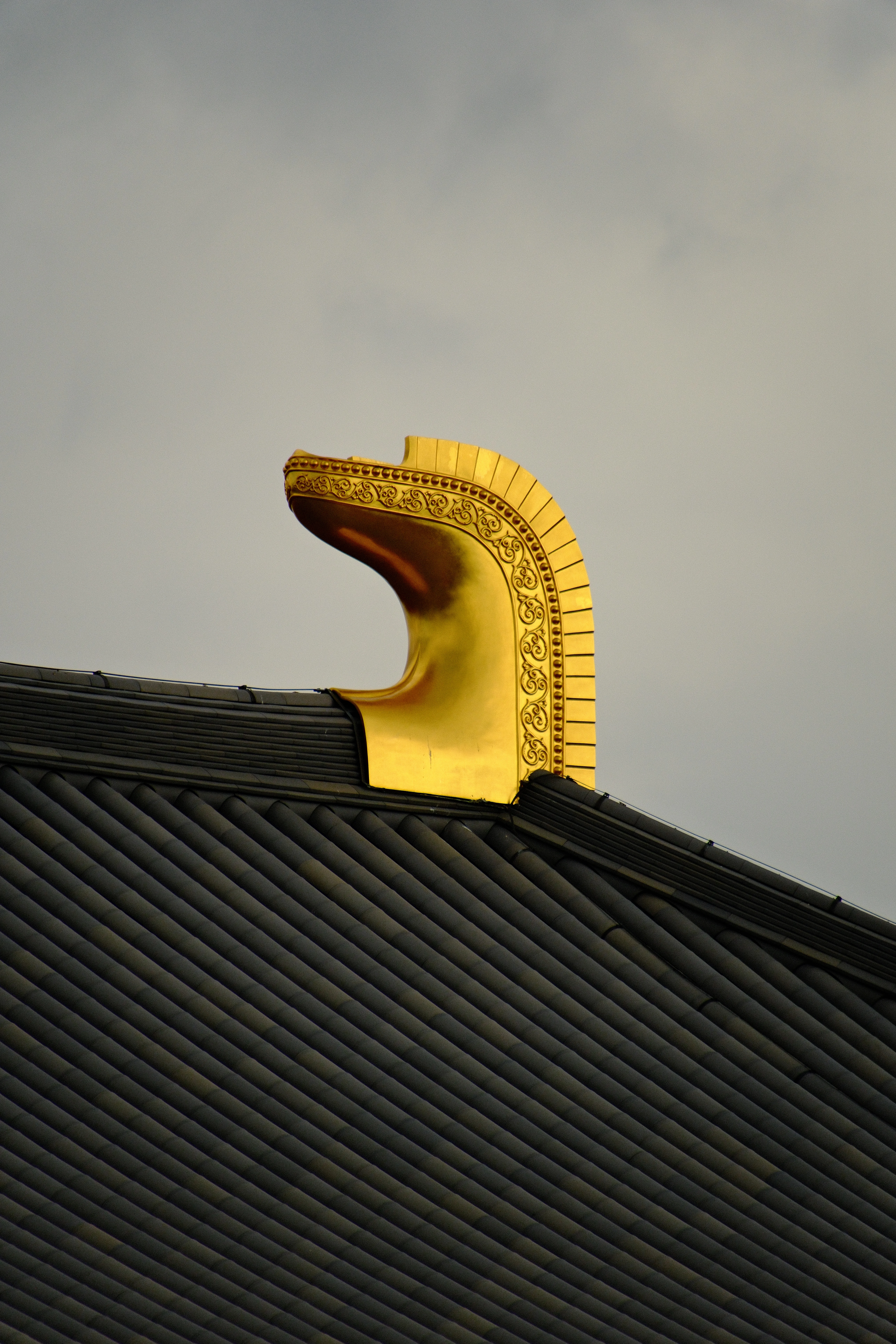 300mm · f/6.7 · 1/1600s · ISO 500
FUJIFILM X-T5 · 16-300mm F3.5-6.7 DC OS | Contemporary 025 · Jan 8, 2026
Golden shibi ornament on a dark tiled Japanese temple roof.
Nara, Japan
© Brandon Cook