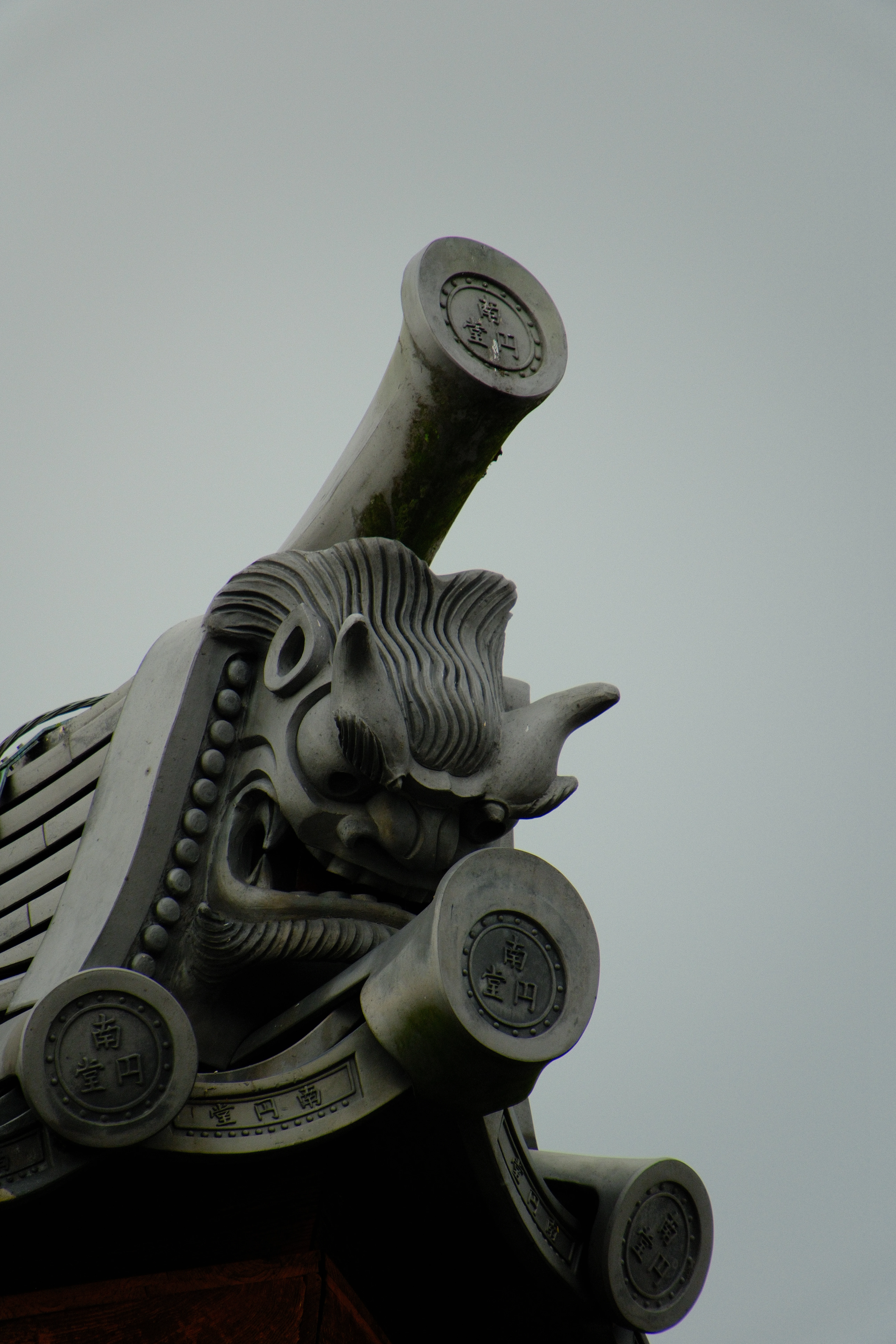 300mm · f/6.7 · 1/600s · ISO 500
FUJIFILM X-T5 · 16-300mm F3.5-6.7 DC OS | Contemporary 025 · Jan 8, 2026
Intricate stone dragon carving on a traditional Japanese roof corner.
Nara, Japan
© Brandon Cook