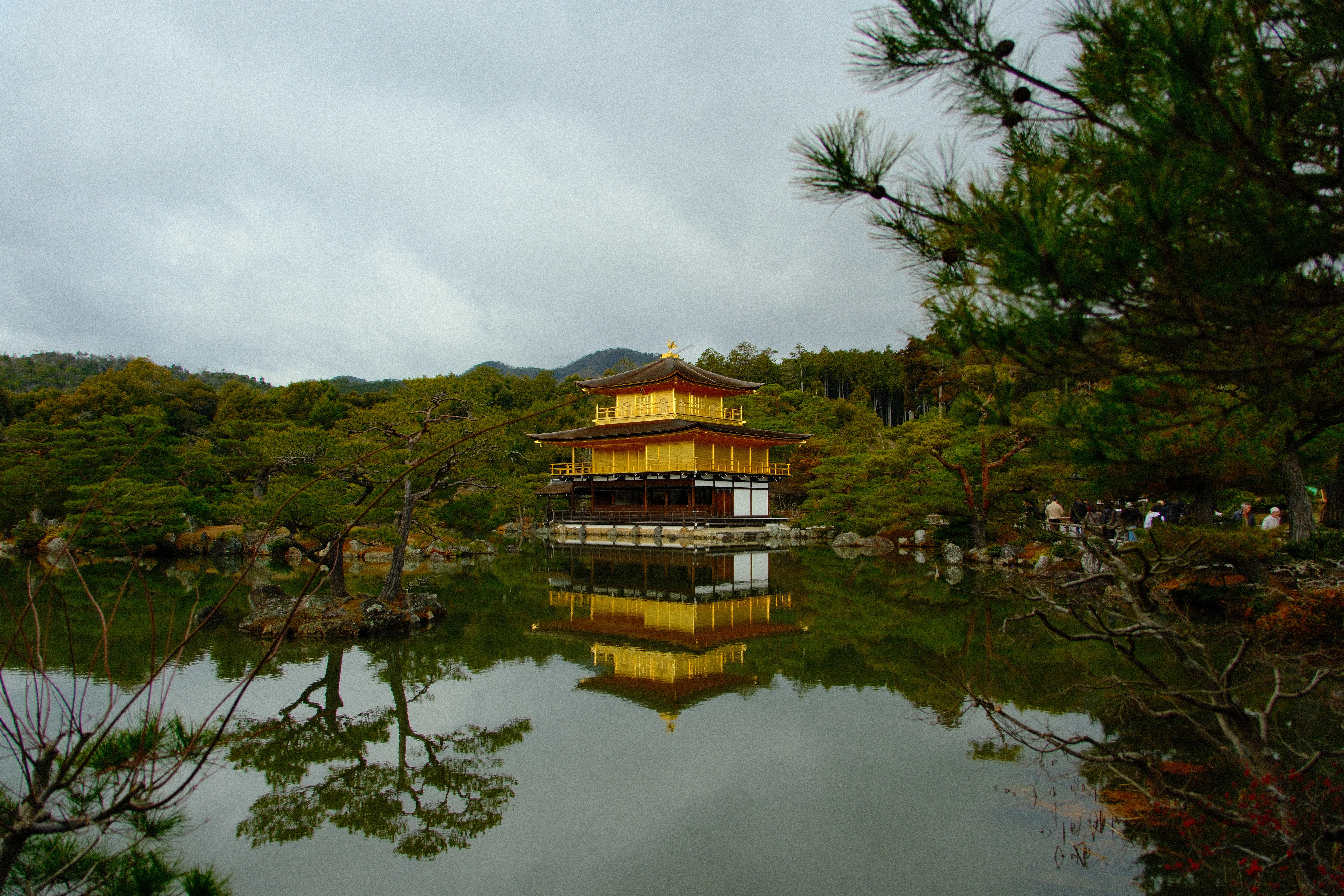 16mm · f/3.5 · 1/1900s · ISO 500
FUJIFILM X-T5 · 16-300mm F3.5-6.7 DC OS | Contemporary 025 · Jan 9, 2026
Golden temple reflecting on a still pond surrounded by greenery.
Kyoto, Japan
© Brandon Cook
