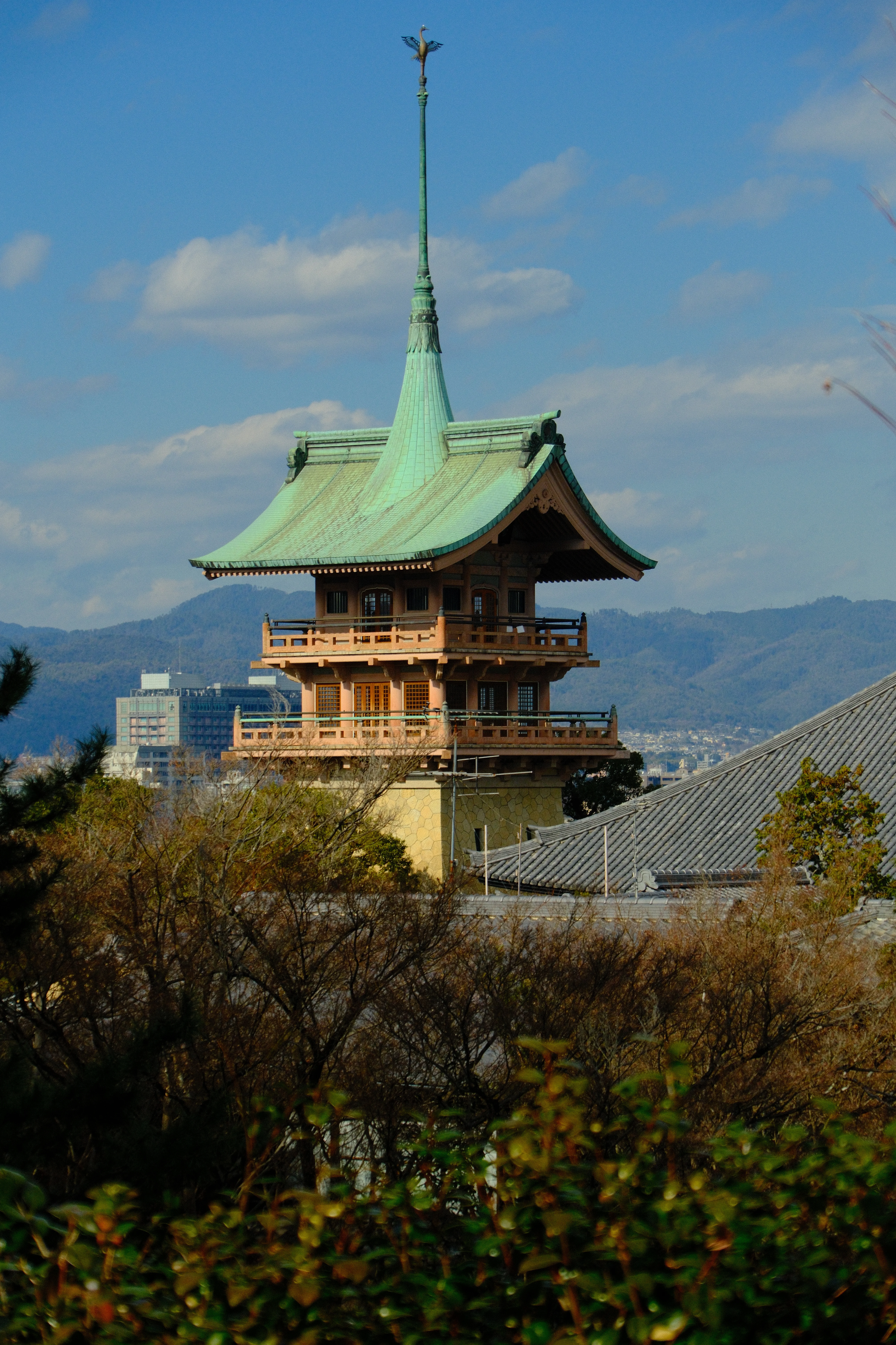 75mm · f/6.3 · 1/3000s · ISO 500
FUJIFILM X-T5 · 16-300mm F3.5-6.7 DC OS | Contemporary 025 · Jan 10, 2026
Traditional green-roofed pagoda overlooks a scenic Kyoto landscape.
Kyoto, Japan
© Brandon Cook