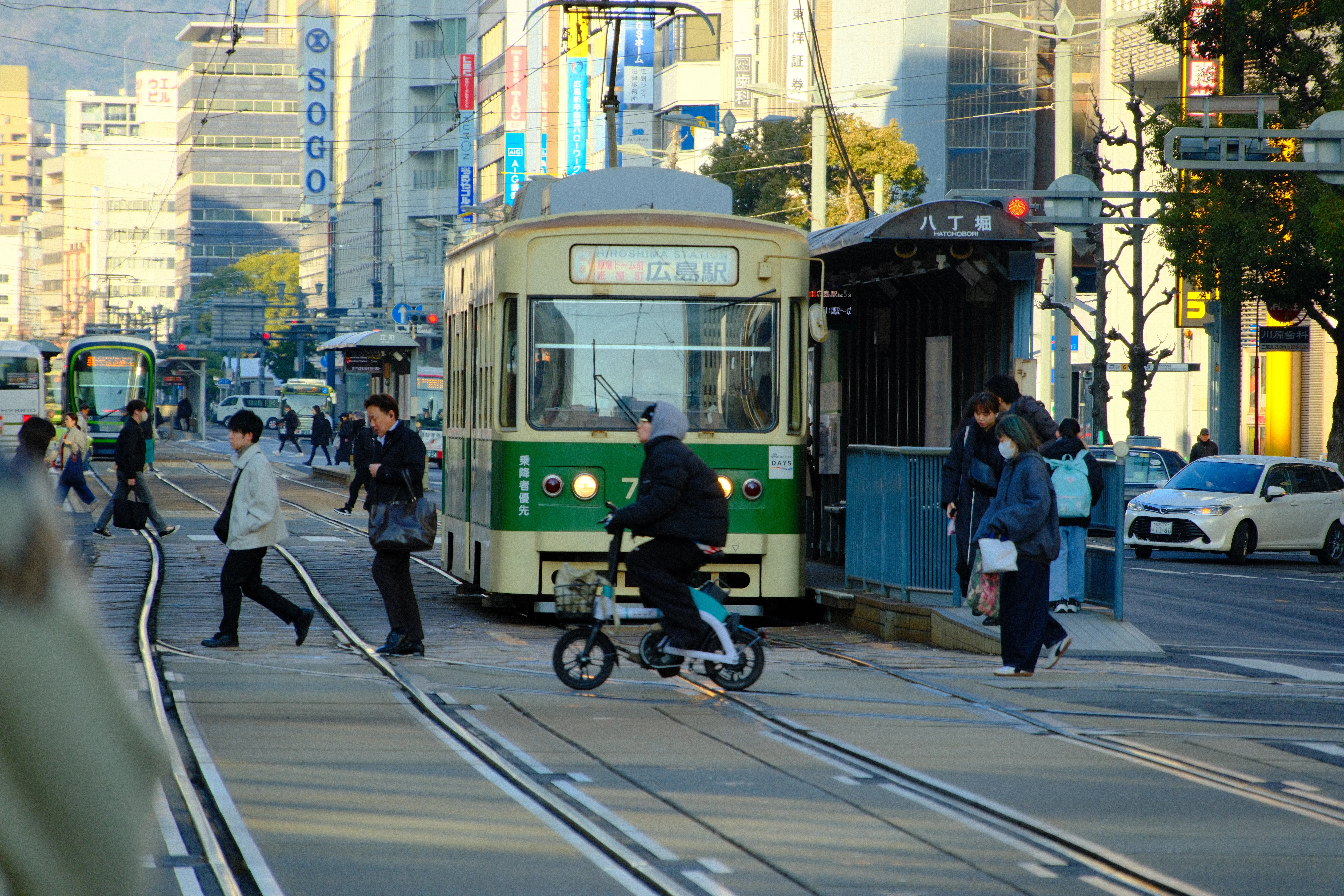 172mm · f/7.1 · 1/300s · ISO 500
FUJIFILM X-T5 · 16-300mm F3.5-6.7 DC OS | Contemporary 025 · Jan 12, 2026
Green streetcar navigates a busy Hiroshima street with pedestrians.
Hiroshima, Japan
© Brandon Cook