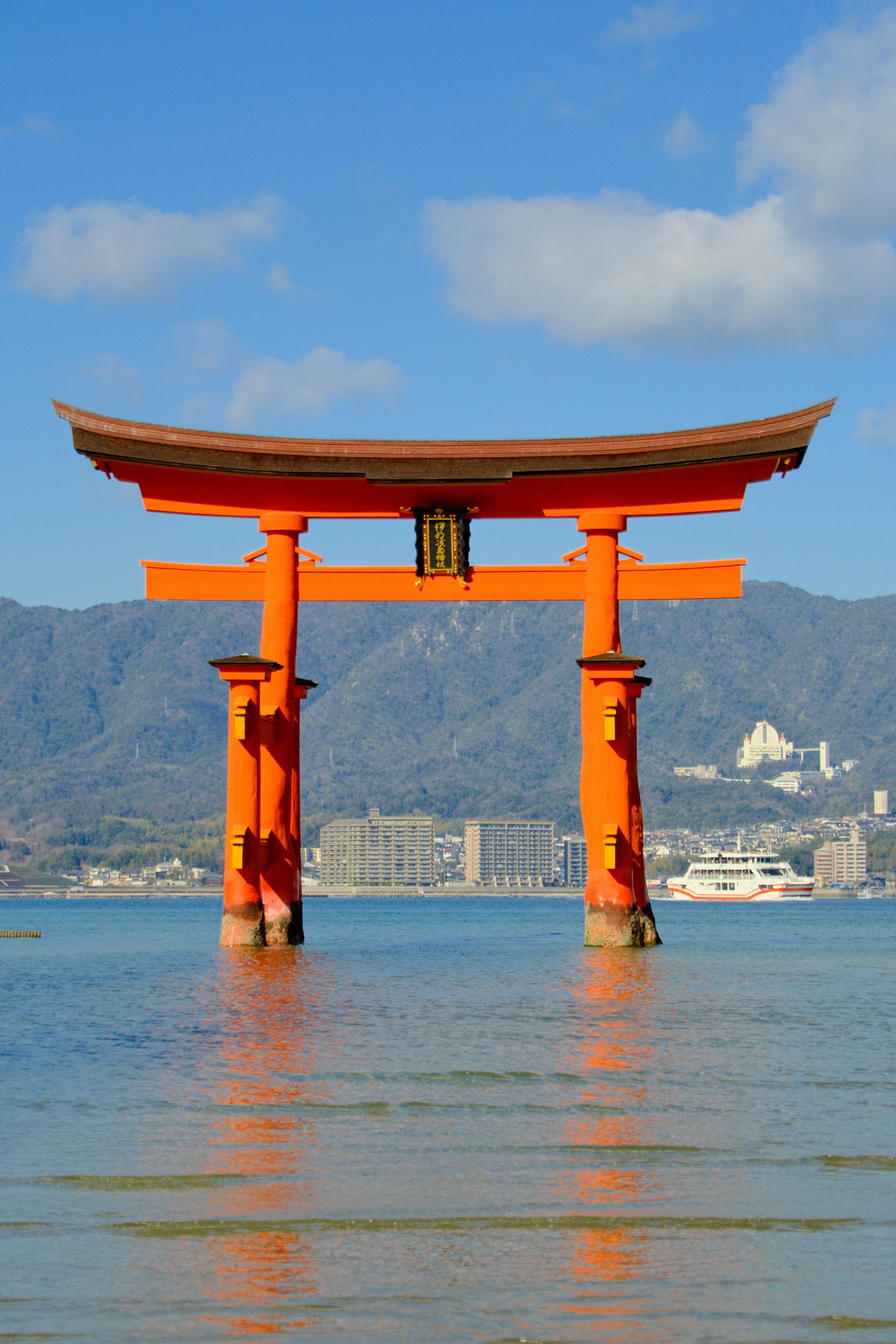 56mm · f/5.6 · 1/2000s · ISO 500
FUJIFILM X-T5 · 16-300mm F3.5-6.7 DC OS | Contemporary 025 · Jan 12, 2026
Orange Itsukushima torii gate in water with mountains and sky.
Hiroshima, Japan
© Brandon Cook