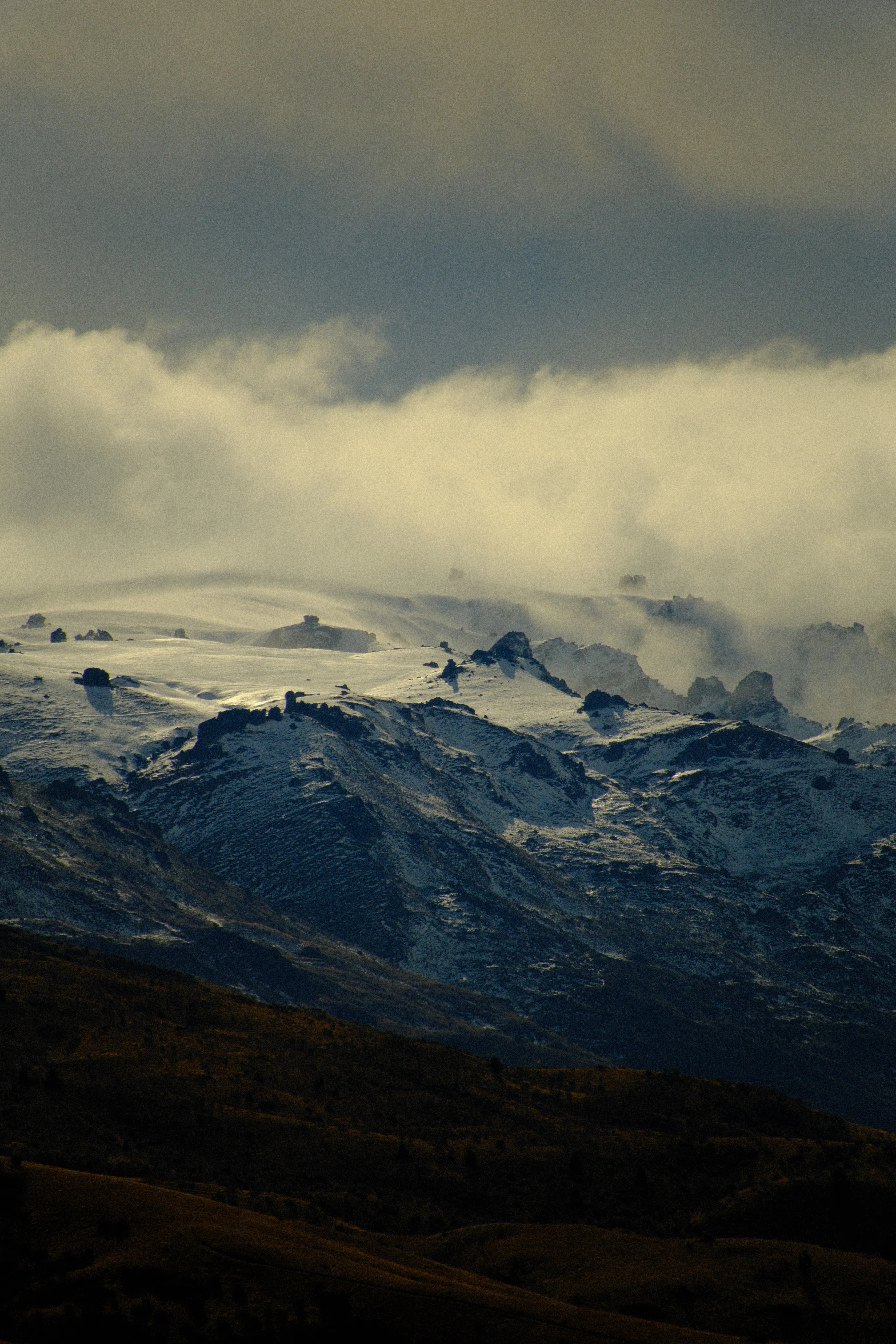 300mm · f/6.7 · 1/4400s · ISO 500
FUJIFILM X-T5 · 16-300mm F3.5-6.7 DC OS | Contemporary 025 · Jul 30, 2026
Snow-covered mountains under a cloudy sky in New Zealand.
Bannockburn, New Zealand
© Brandon Cook